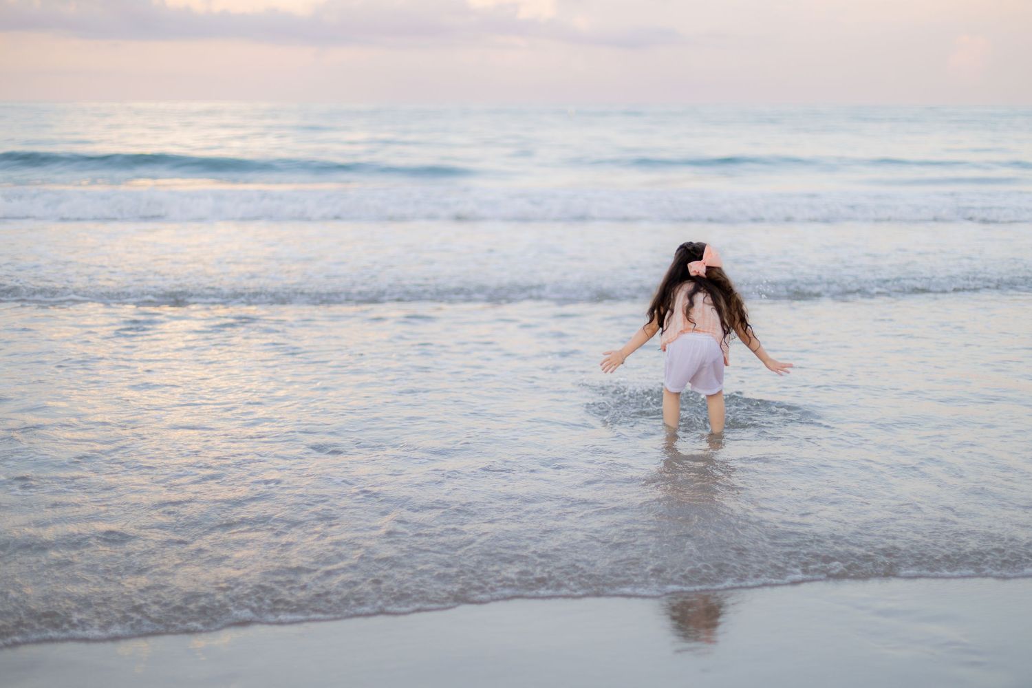 candid picture of child playing on beach during family photoshoot in deerfield beach