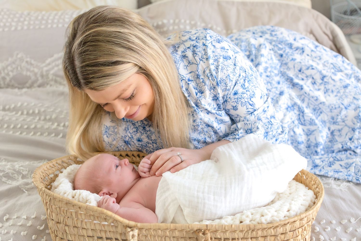 Mother on looking down at her newborn baby during North Georgia lifestyle newborn photography session near Athens GA.