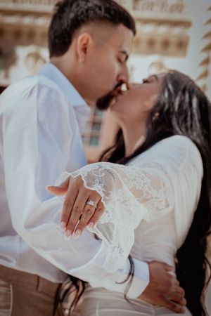A romantic wedding photoshoot series showing close-up details of an engagement ring and white lace dress.