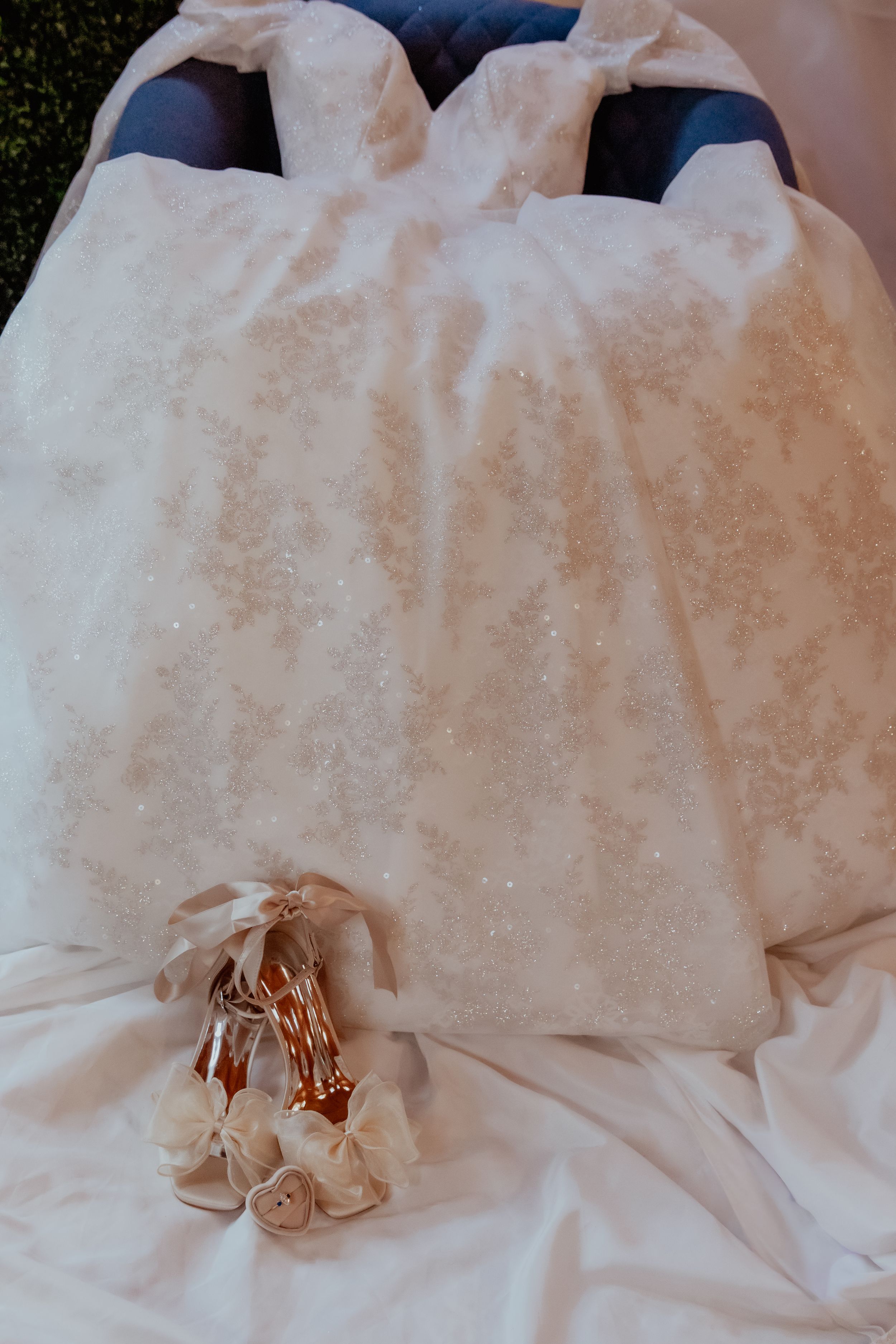 A series of images showing a white towel being folded into an elegant rose shape through step-by-step progression.