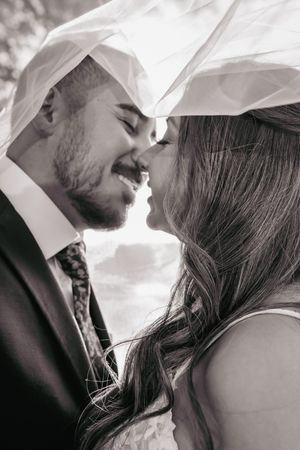 A romantic black and white photo series showing a couple in intimate close-up moments sharing tender kisses.