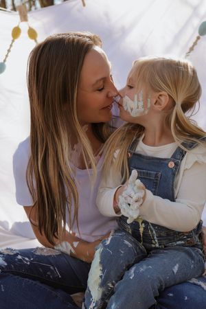 Tender moment shared during creative painting activity.