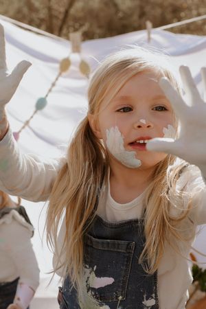 Playful sequence showing laughter and joy while playing with paint. Family photography.