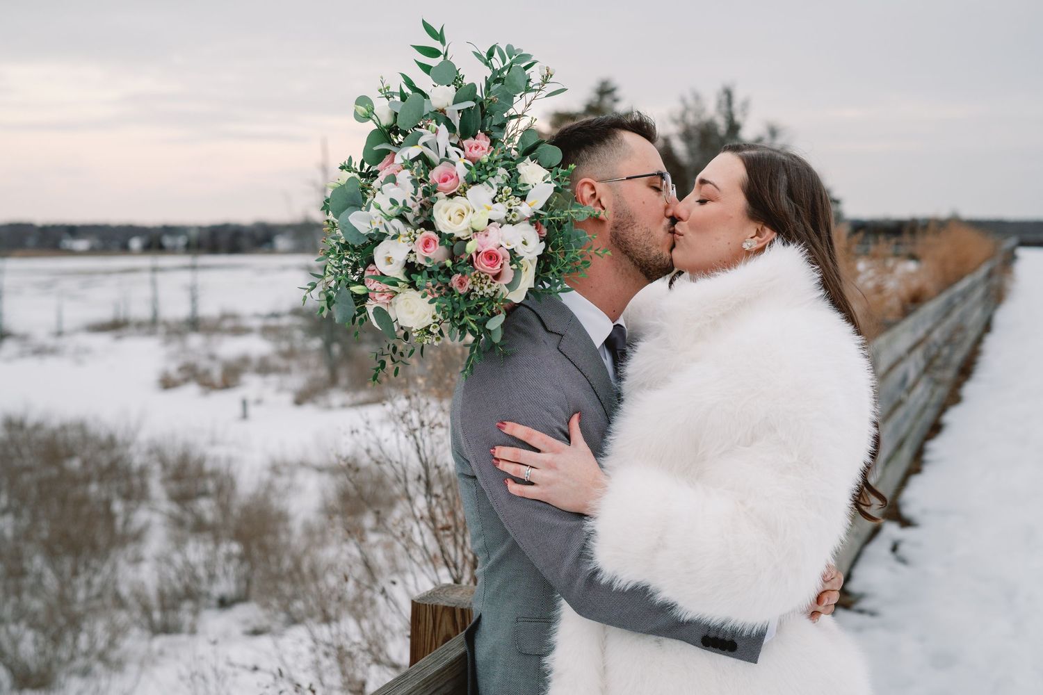 A romantic winter wedding photo series showing couples embracing in a snowy landscape with elegant floral bouquets.