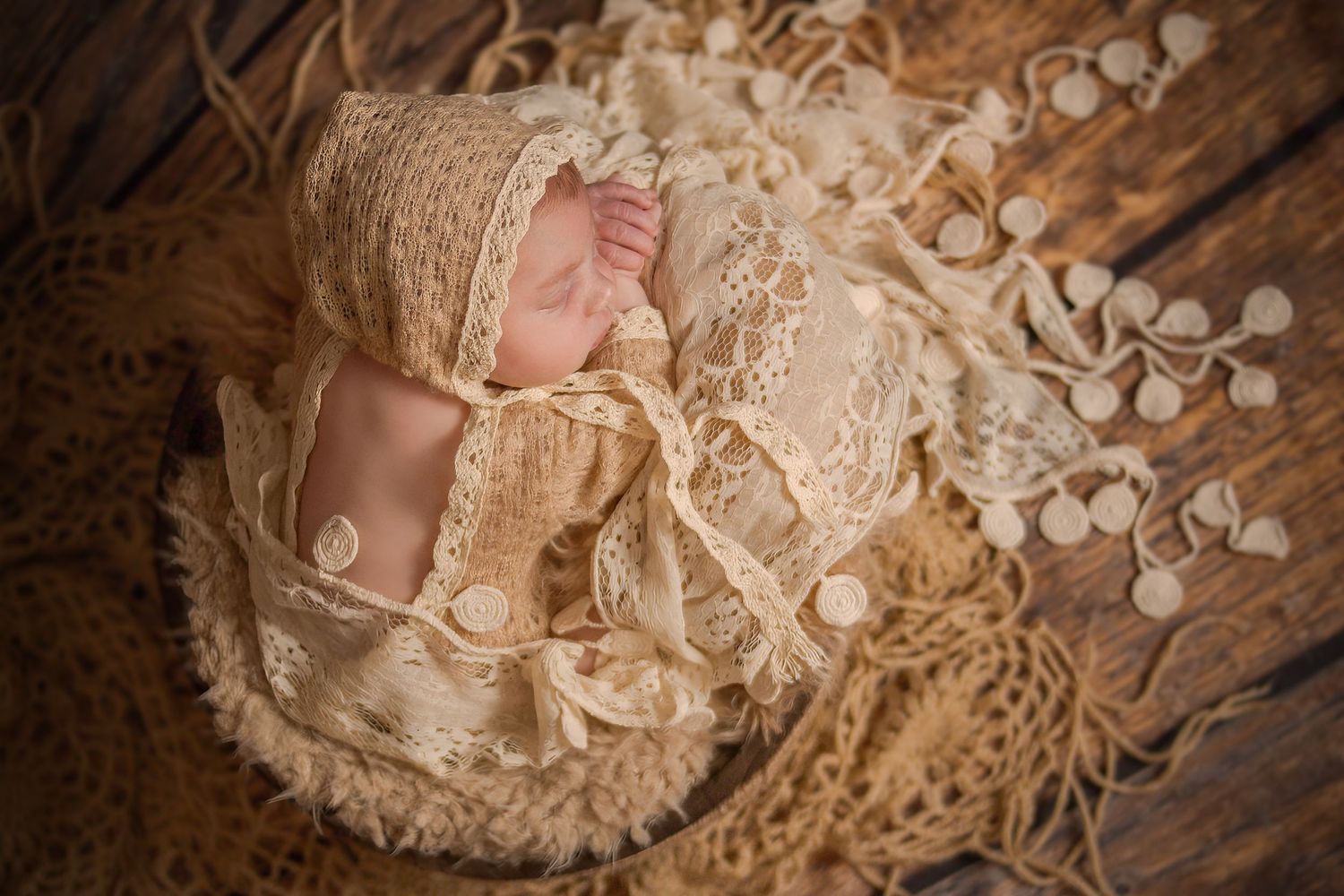 newborn baby sleeping in wooden prop on draping lace and crocheted fabrics - Mississauga Newborn Photographer - Studio Session