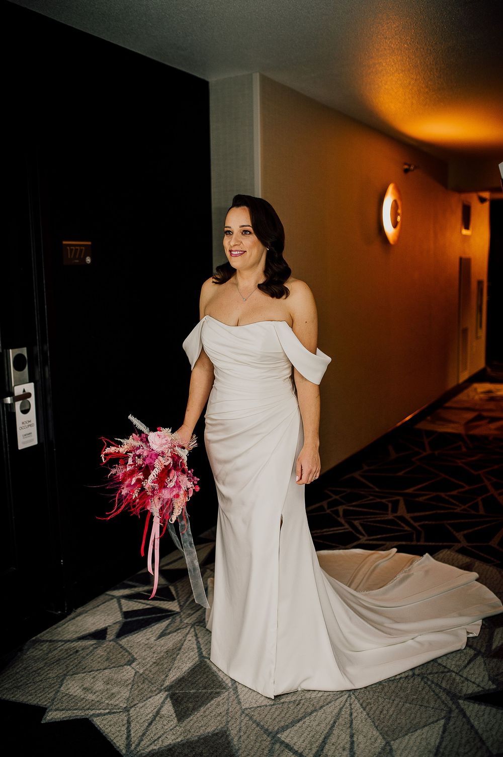 A series of photos showing a bride in a flowing white wedding dress walking down a dimly lit hotel hallway.