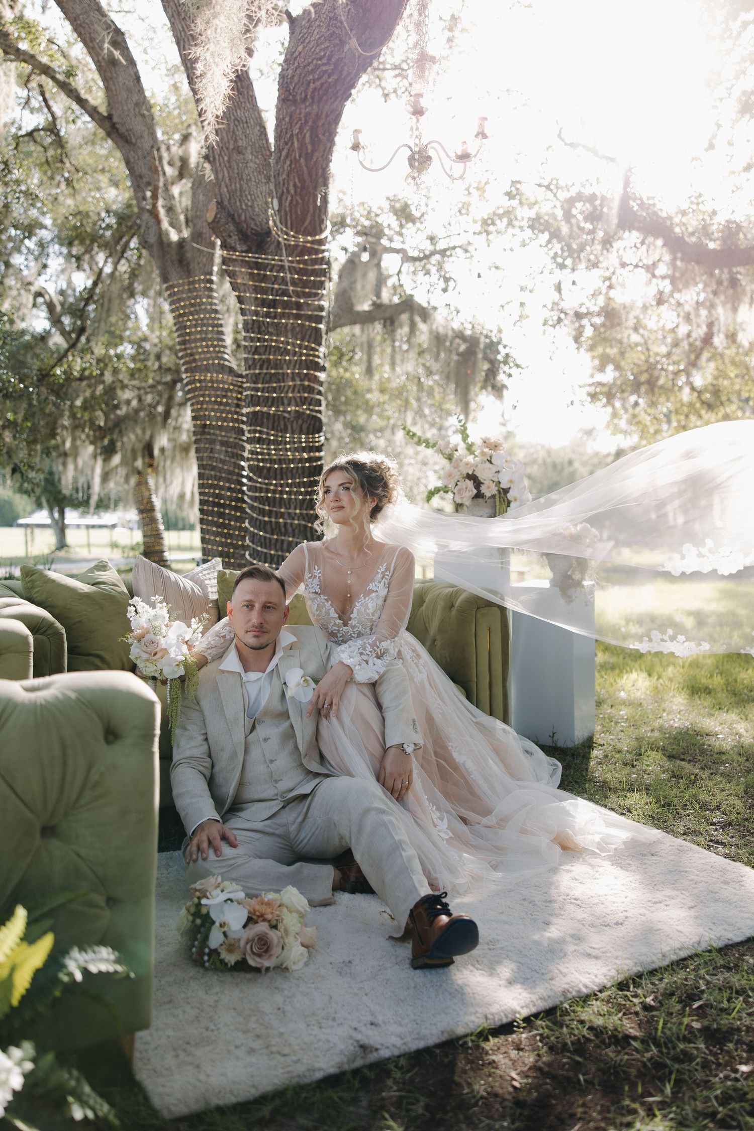 Wedding dress and veil detail shots on wooden church pews surrounded by trees.