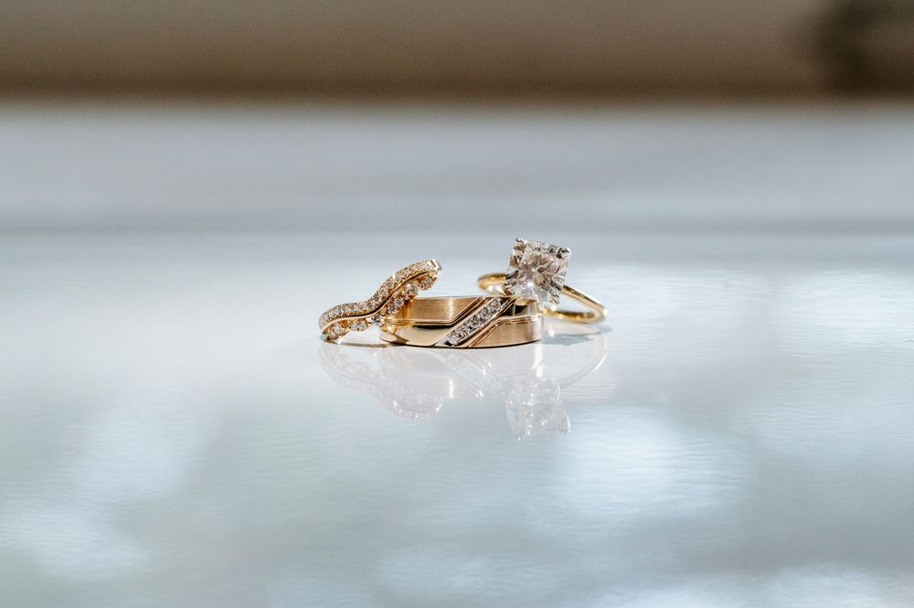 A tiny brown lizard runs across a reflective white surface creating multiple mirror-like reflections.