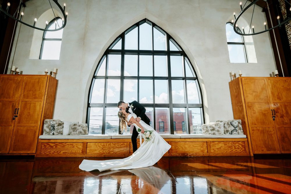 Arched windows and wooden beams create an architectural panorama in a rustic interior space.