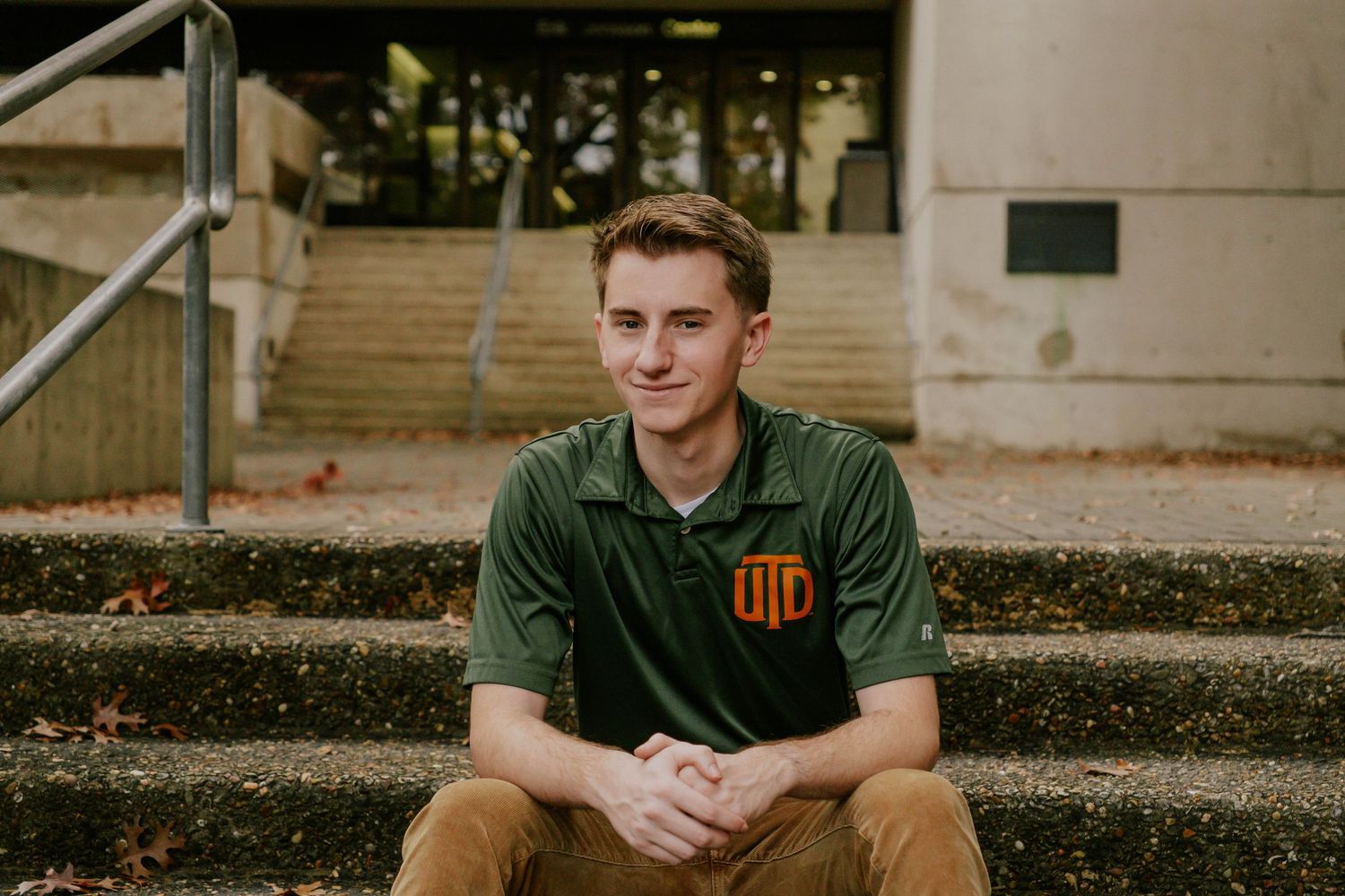 Outdoor senior portrait session near campus buildings and steps. UTD Graduate Portraits by Eric Aaberg Photography in DFW.