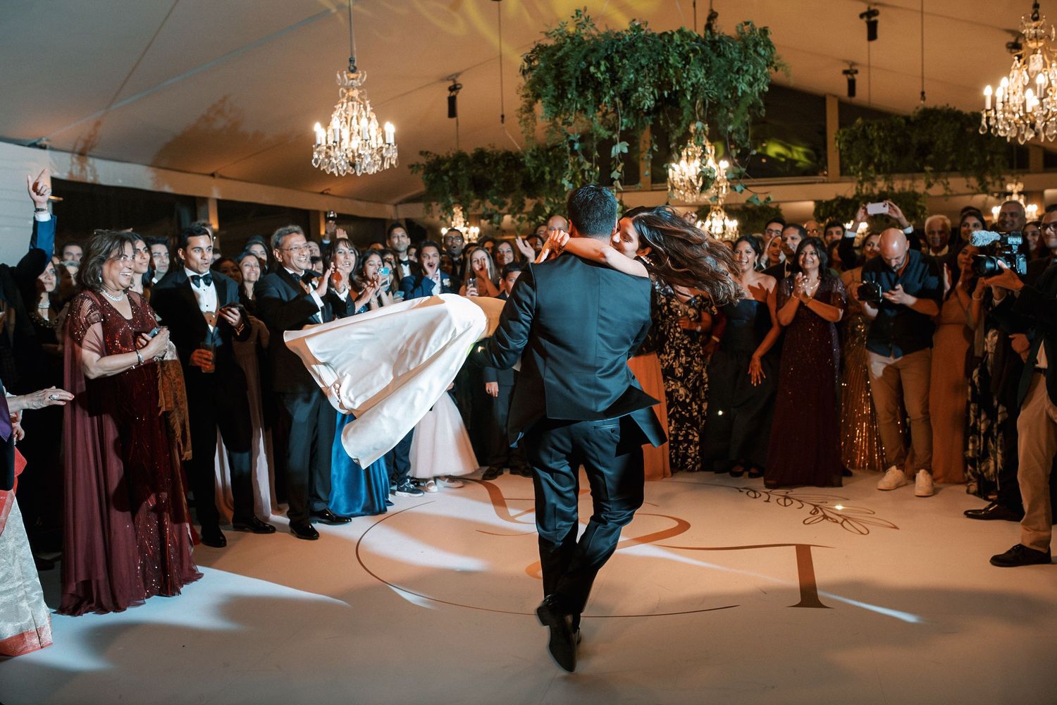 Bride and groom first dance surrounded by guests at luxury Indian wedding reception in Portugal at Corrio-Mor palace