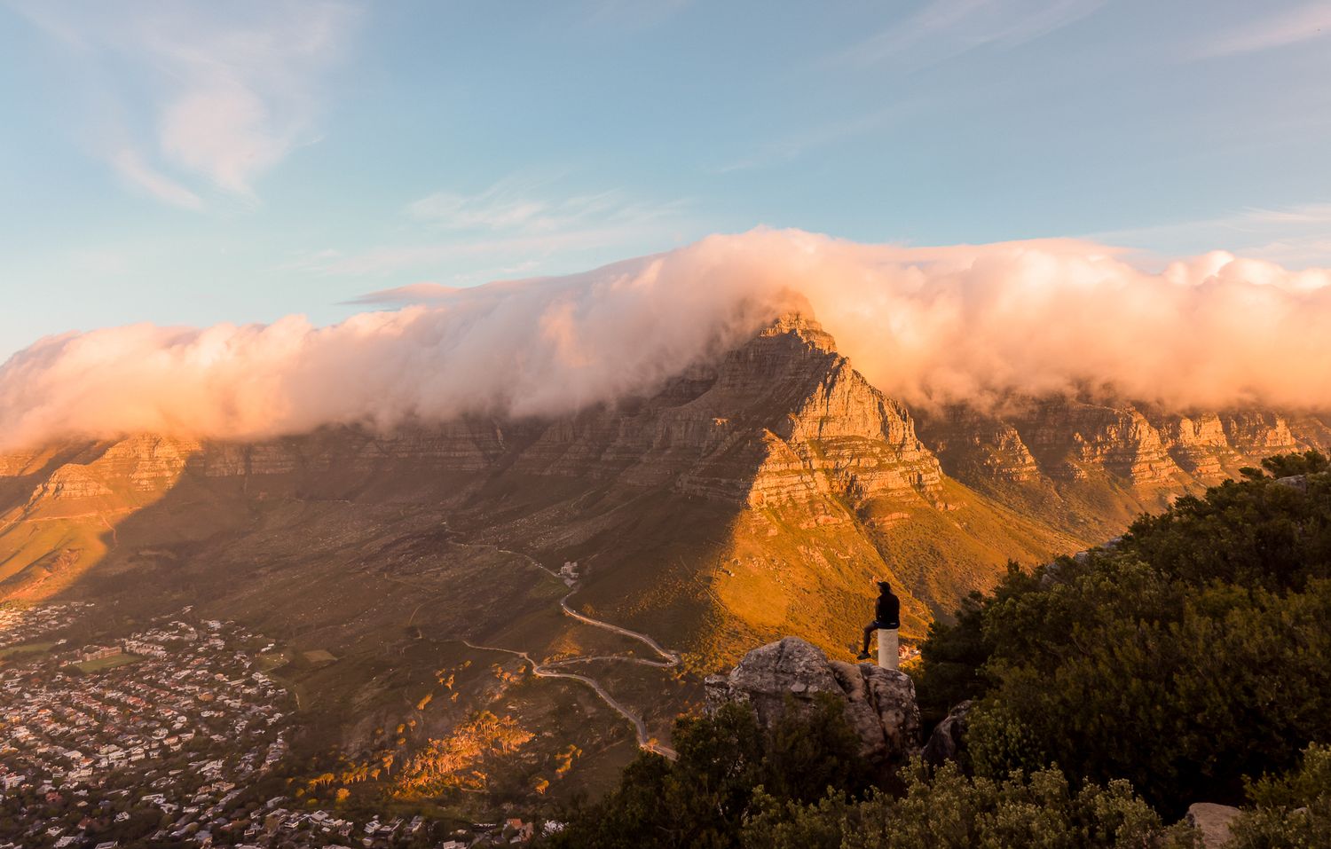 Panoramic mountain landscape at sunset with golden light on peaks.