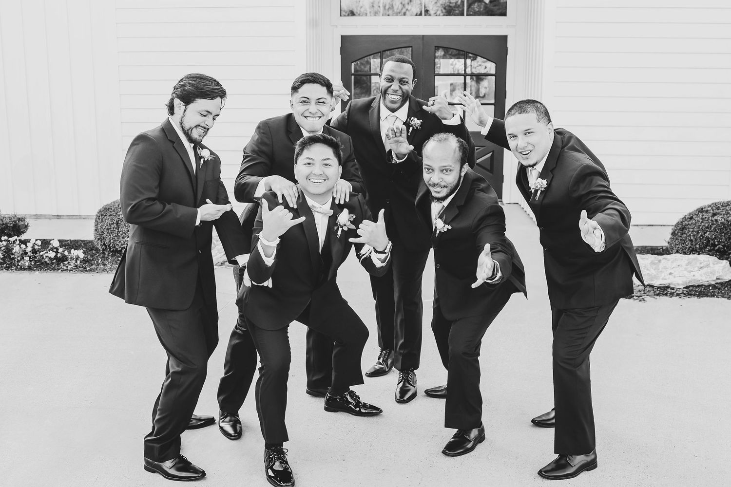 Groomsmen laughing together before ceremony in candid moment