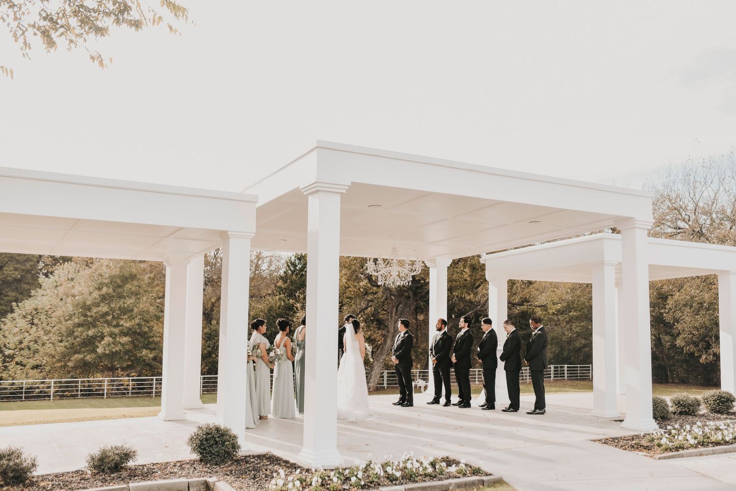 Bride and groom exchanging vows during outdoor ceremony