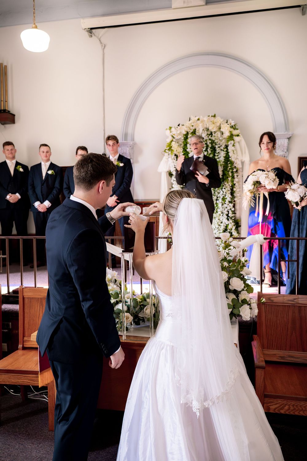 A wedding ceremony sequence showing special moments between the couple at the altar in a traditional church setting.