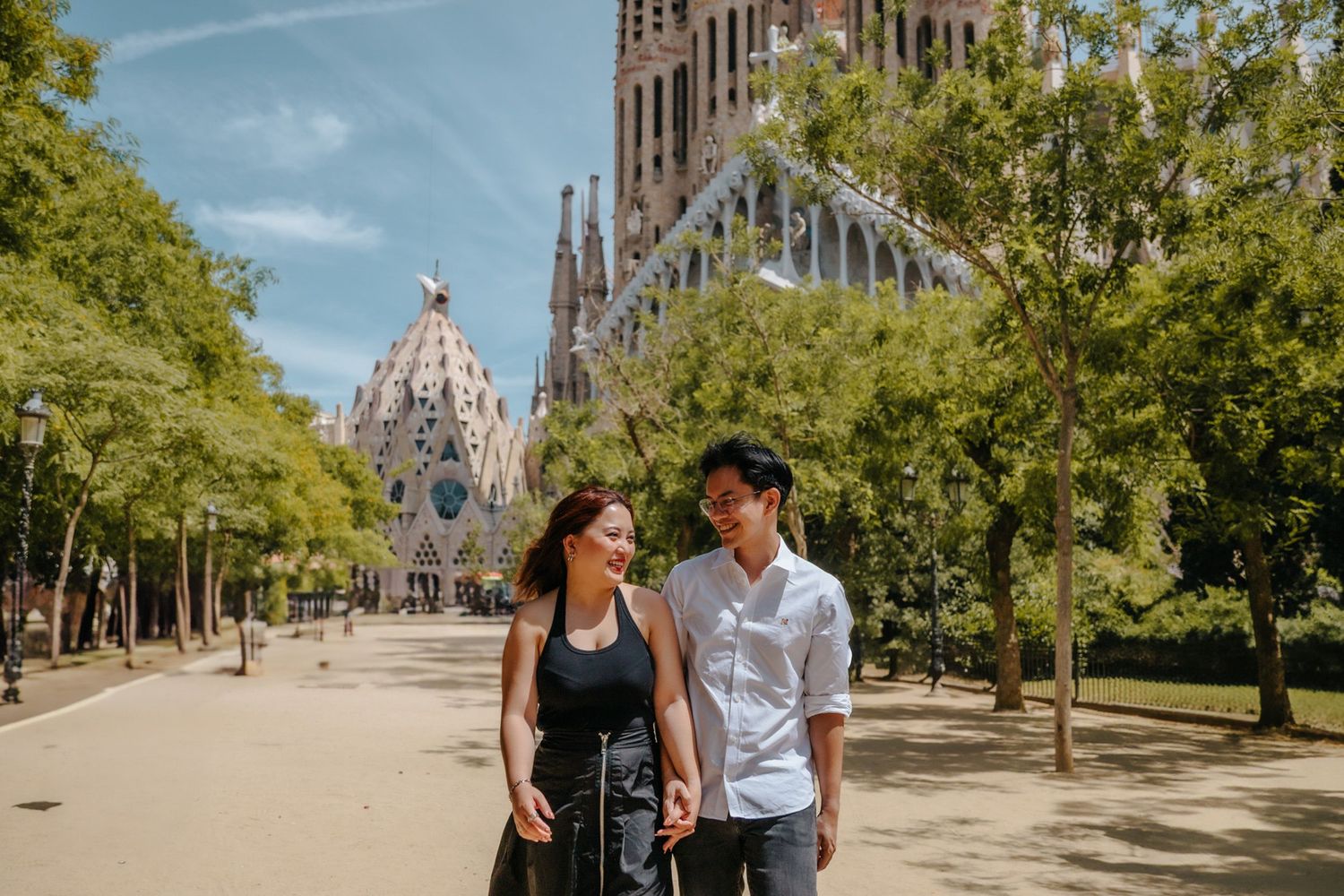 Candid reaction during surprise proposal with iconic Barcelona basilica behind