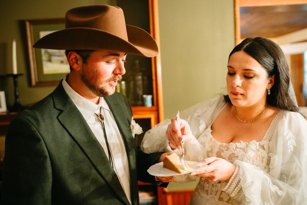A couple shares an intimate moment while dining together at a restaurant table.