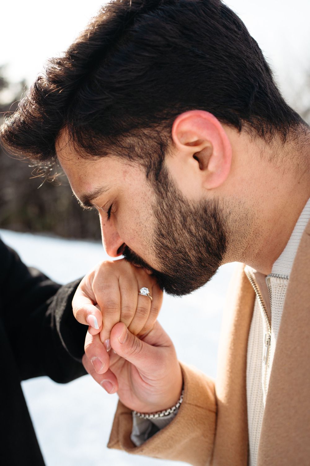 A person in a tan sweater is shown from multiple angles covering their face with their hand.