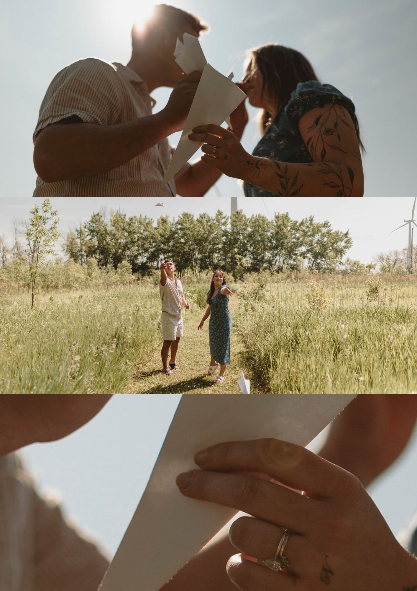 couple play with paper airplanes in a field. windmills in the background.