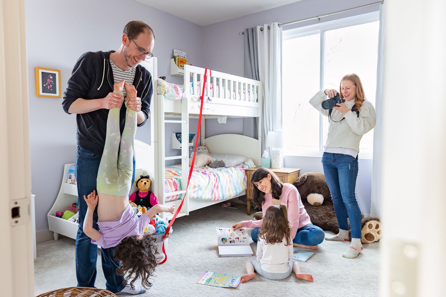 Four connected images show a family playing and having fun together in a bright, modern living room.