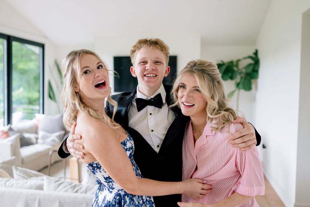 A group of people share joyful moments and laughter during a formal celebration event.