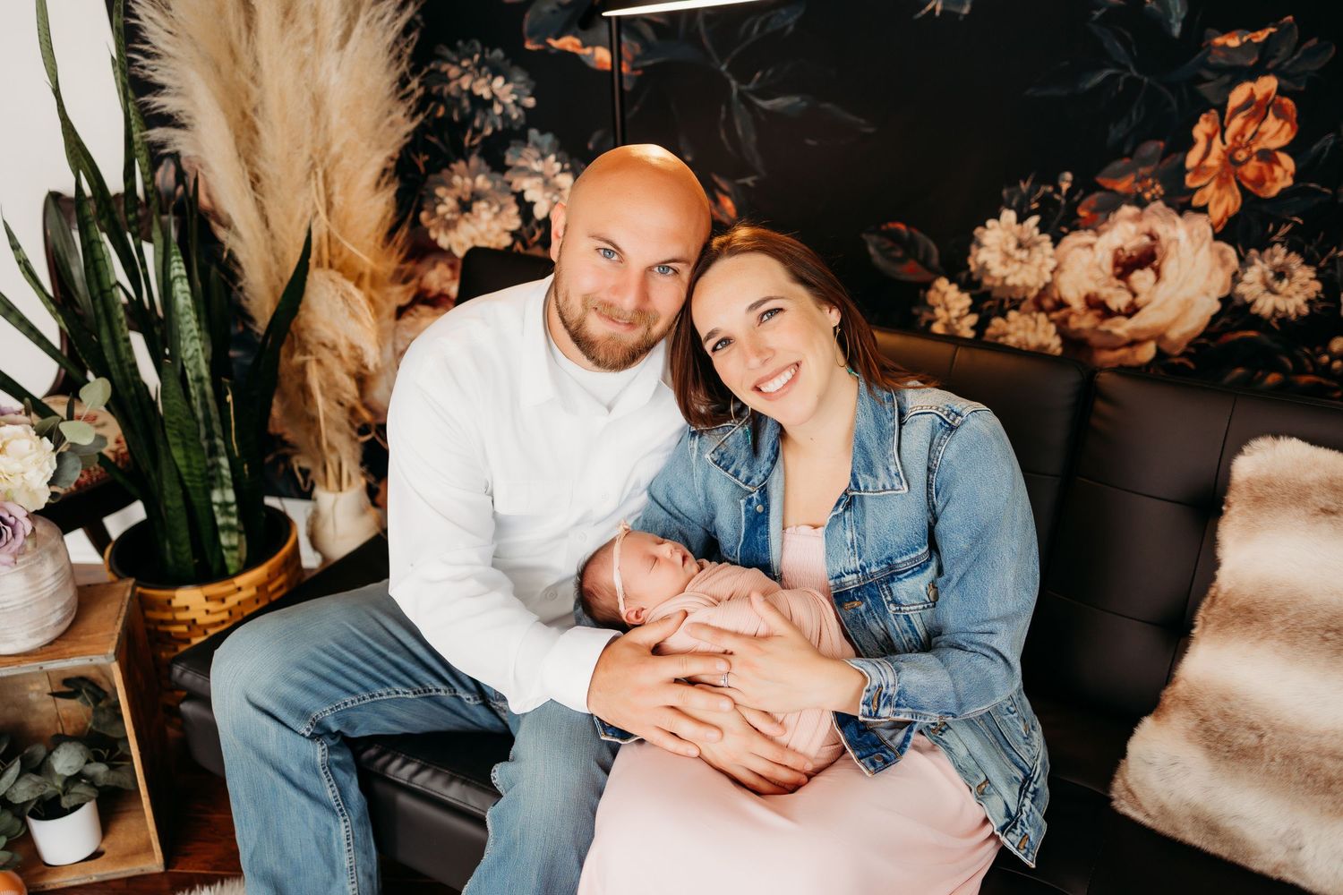 Mom and dad holding newborn baby girl professional photography