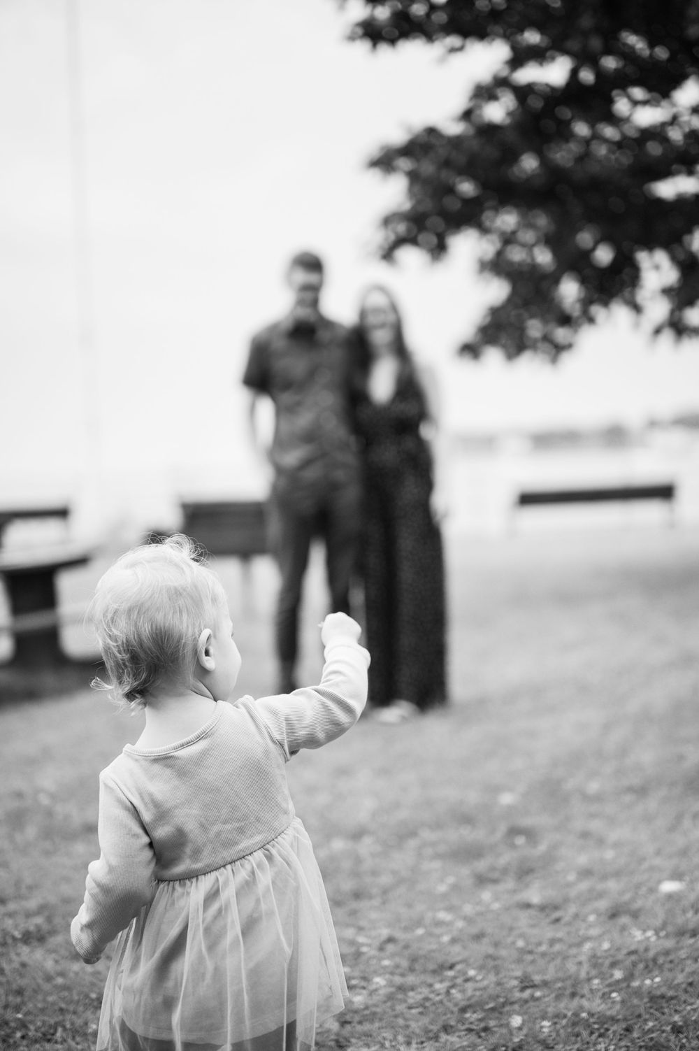Black and white portrait of toddler running on grassy hill. Mini Session Branford point branford Connecticut