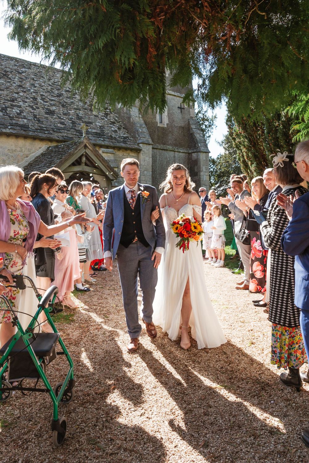 Elmore Court Wedding by Cotswolds Zara Davis Photography in Gloucestershire confetti outside of church at emore