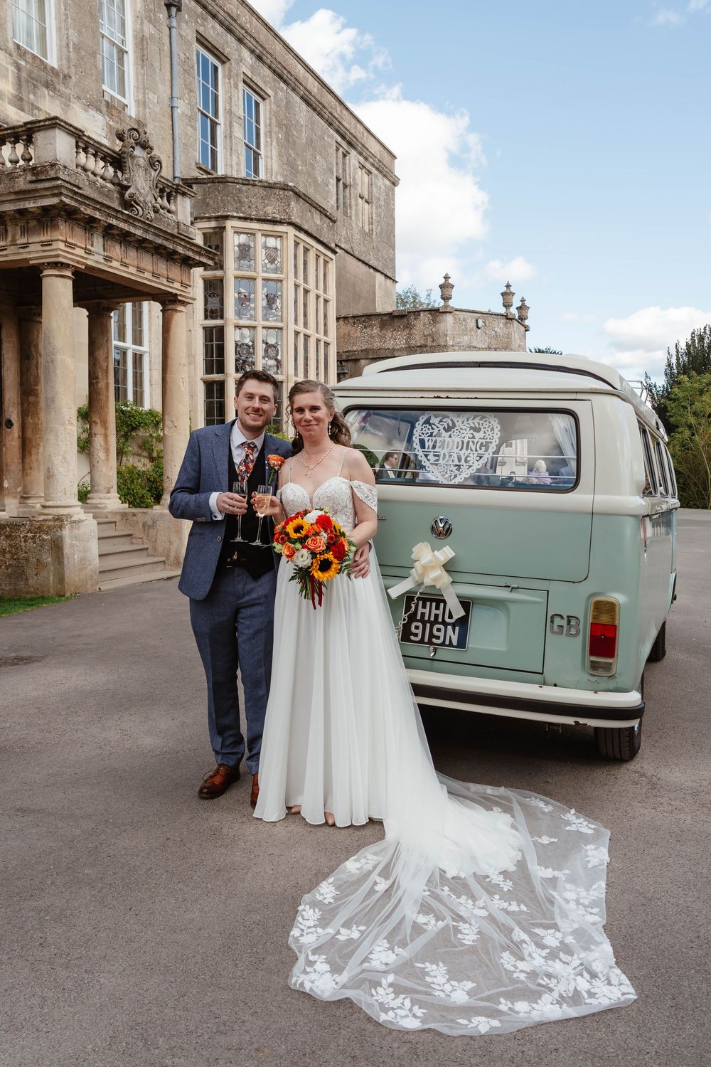 Elmore Court Wedding by Cotswolds Zara Davis Photography in Gloucestershire bride and groom with VW camper outside main house