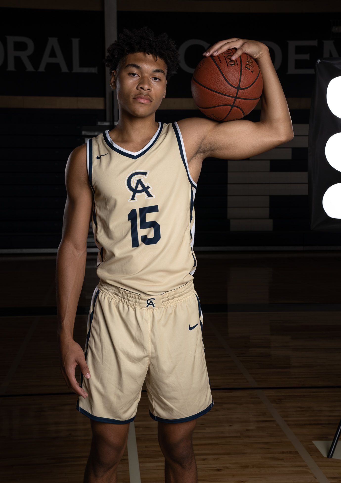 Cathedral Academy basketball players in cream and navy uniforms standing in an indoor gymnasium for team portraits in Charleston South Carol
