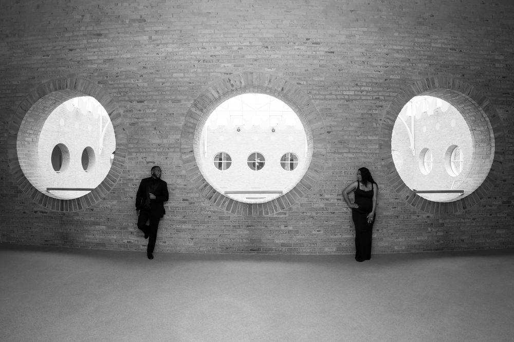 A series of black and white images showing a figure silhouetted against illuminated circular windows in a dark space.