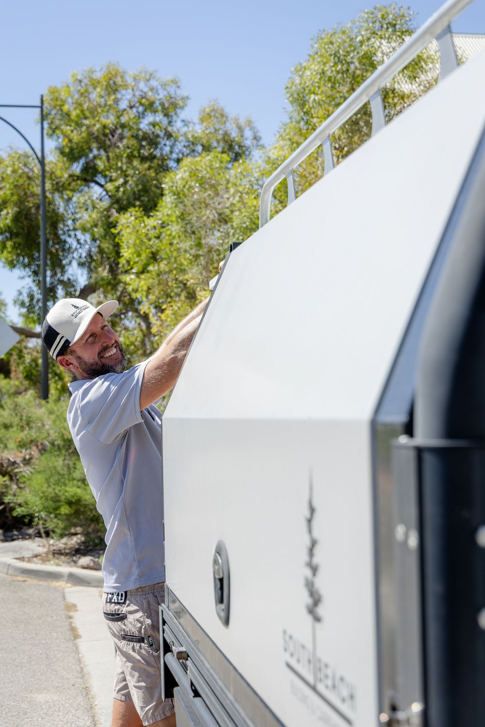 Tradie packing his gear into a truck outside a suburban Compose branding photography