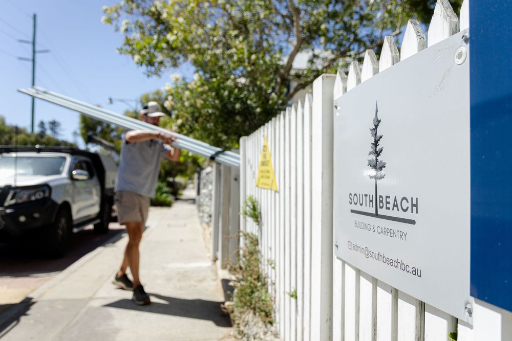Branding photography of South Beach Building and Carpentry showing a tradie walking past carrying materials