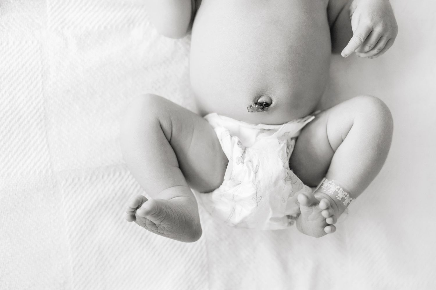 Fresh 48 photo session in Mason City Mercy Hospital with a close up black and white detail of baby's belly