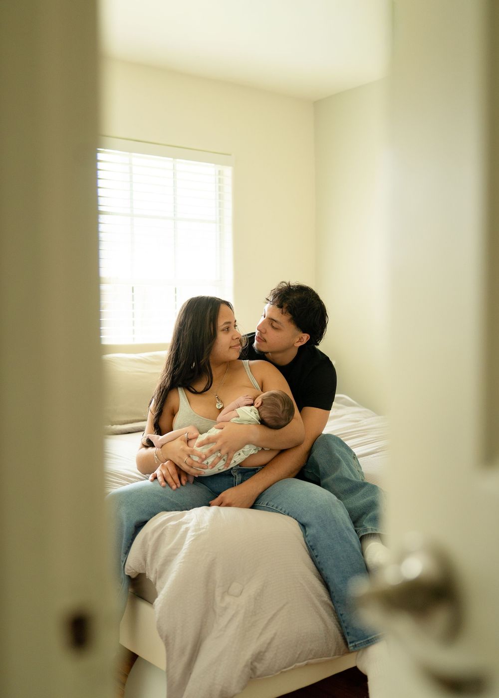 First-time parents cuddling newborn during relaxed Houston lifestyle session