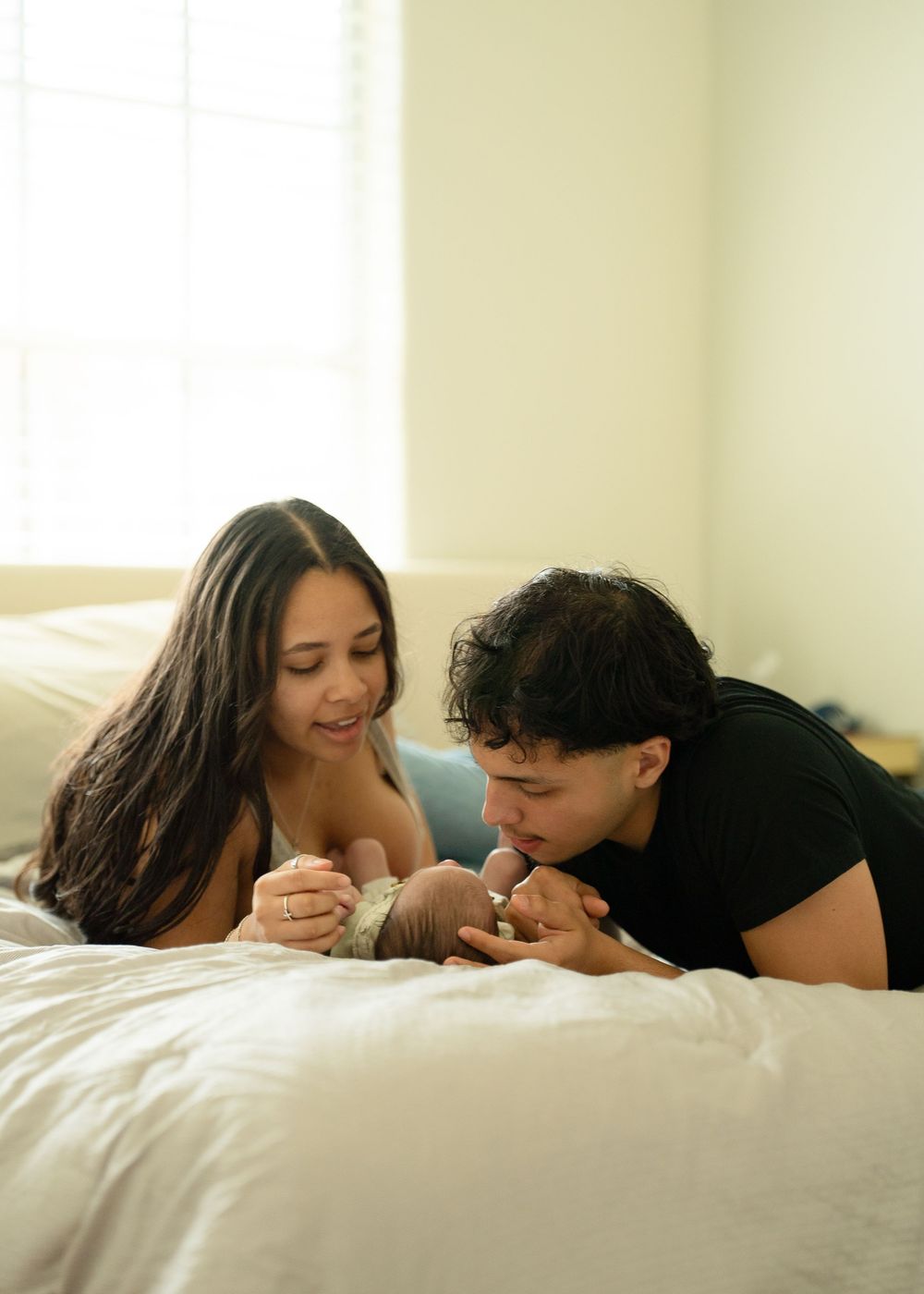 First-time parents cuddling newborn during relaxed Houston lifestyle session