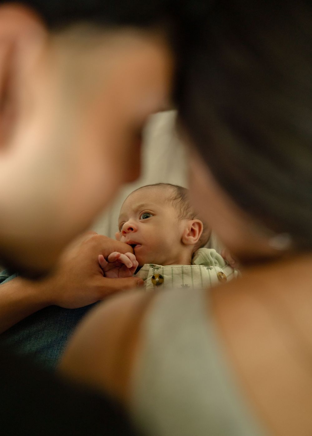 First-time parents cuddling newborn during relaxed Houston lifestyle session