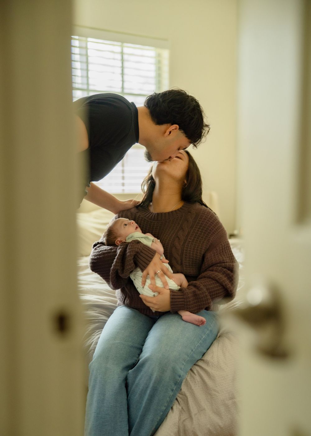 First-time parents cuddling newborn during relaxed Houston lifestyle session