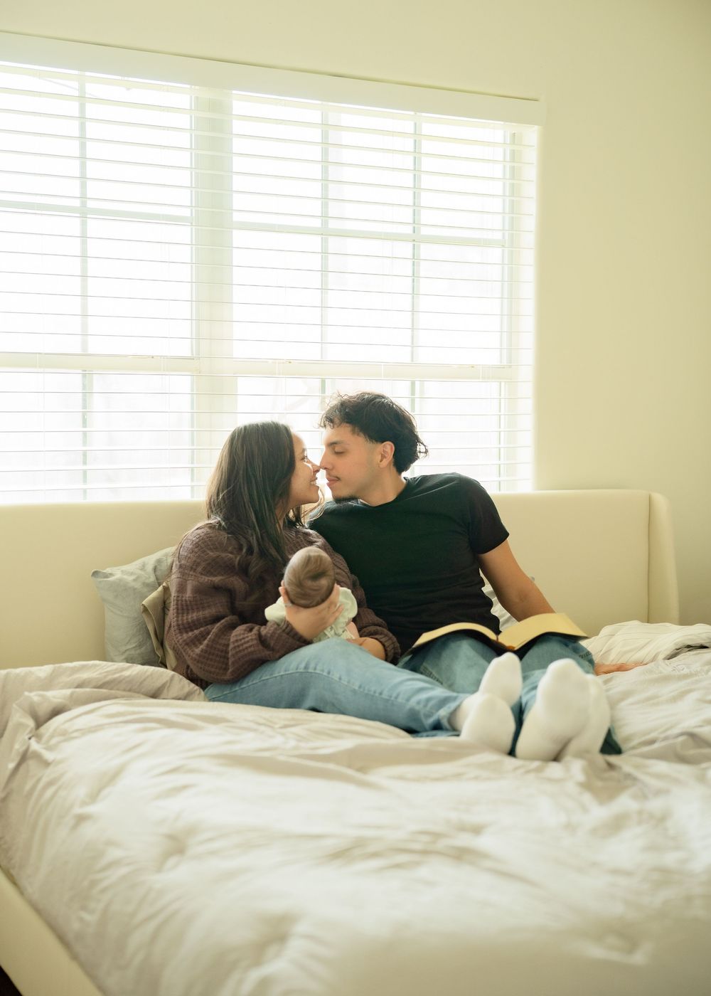 First-time parents cuddling newborn during relaxed Houston lifestyle session