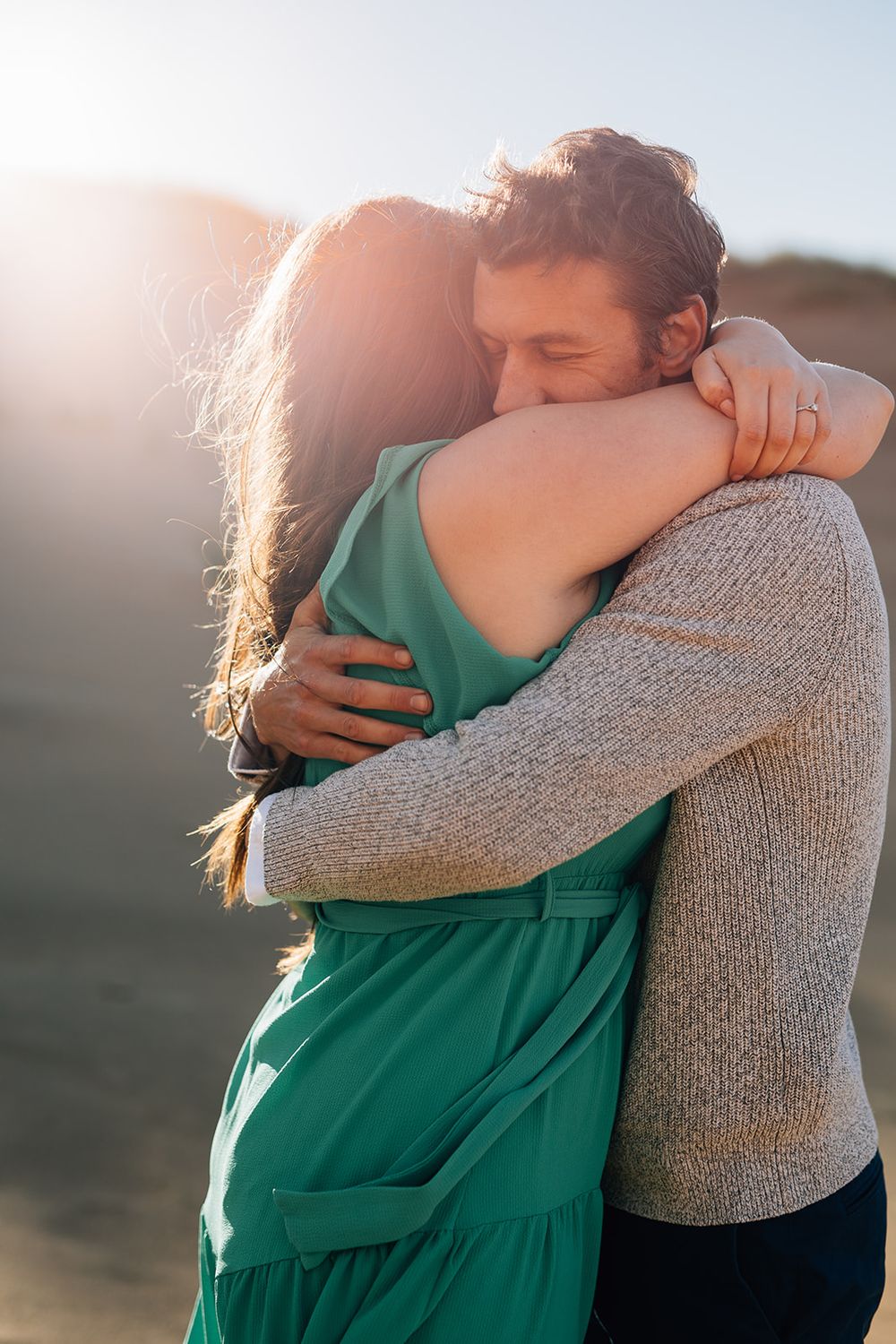 A series of intimate embraces between two people in warm sunlight, with one wearing a green top and another in gray.