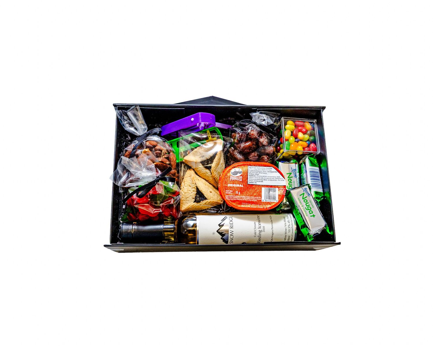 Assorted snack foods and candy bars arranged in a row on a dark surface.