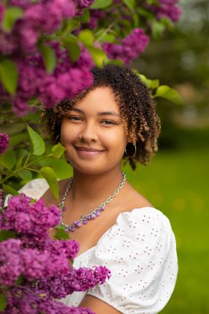 Young-Lady-Smiling-and-posing-in-Lilac-flowers-in-Shepherd-Michigan.