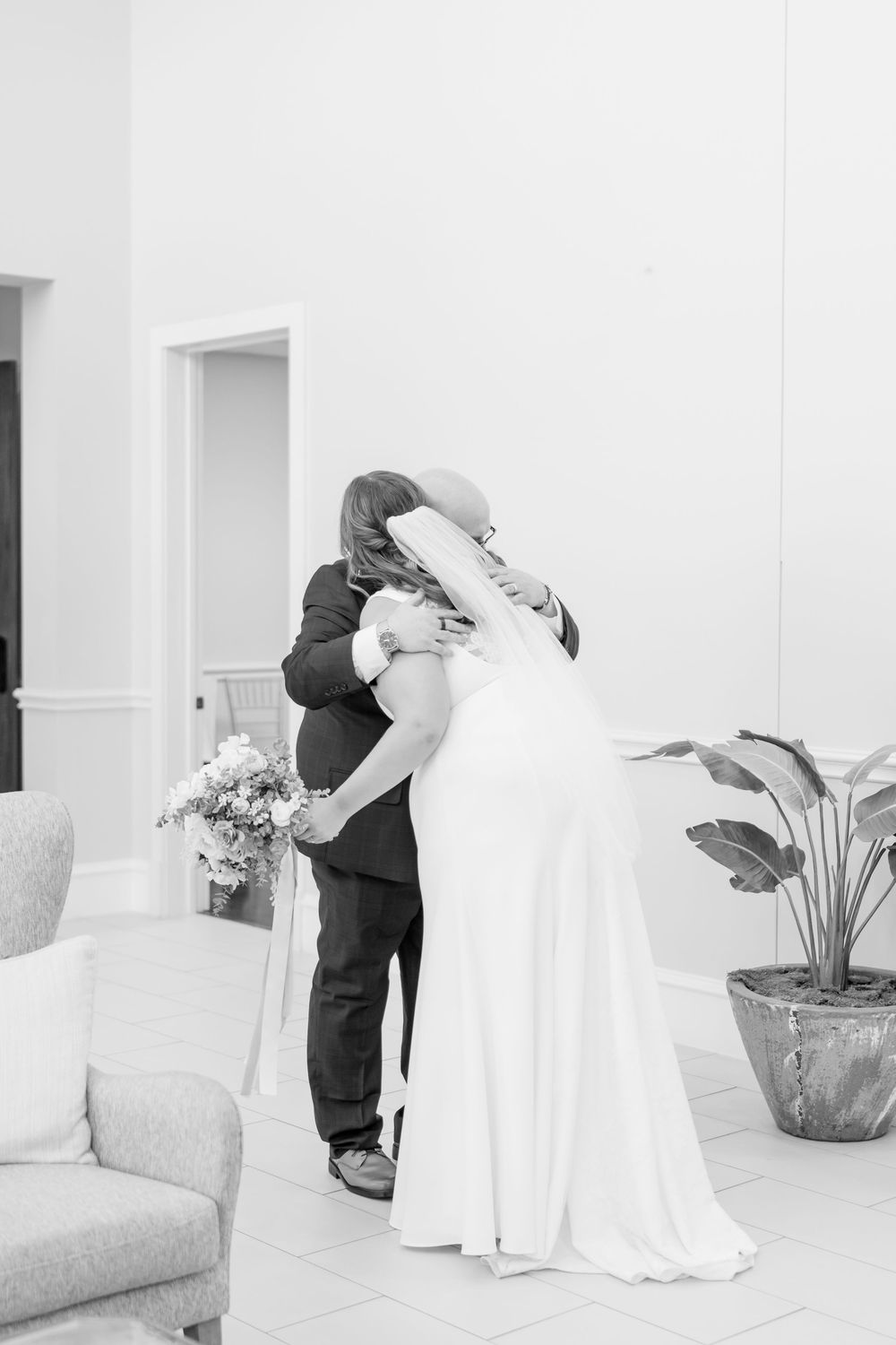 Intimate black and white wedding moment captured in an elegant indoor setting. DALLAS WEDDING PHOTOGRAPHER
