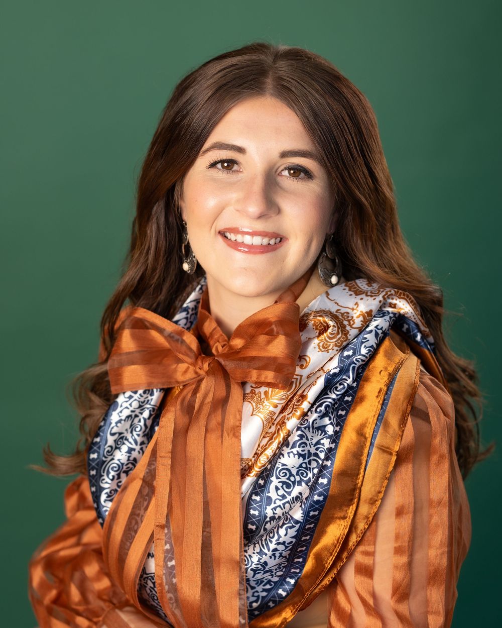 Portrait series showing person in orange and blue outfit with copper-colored bow accents.