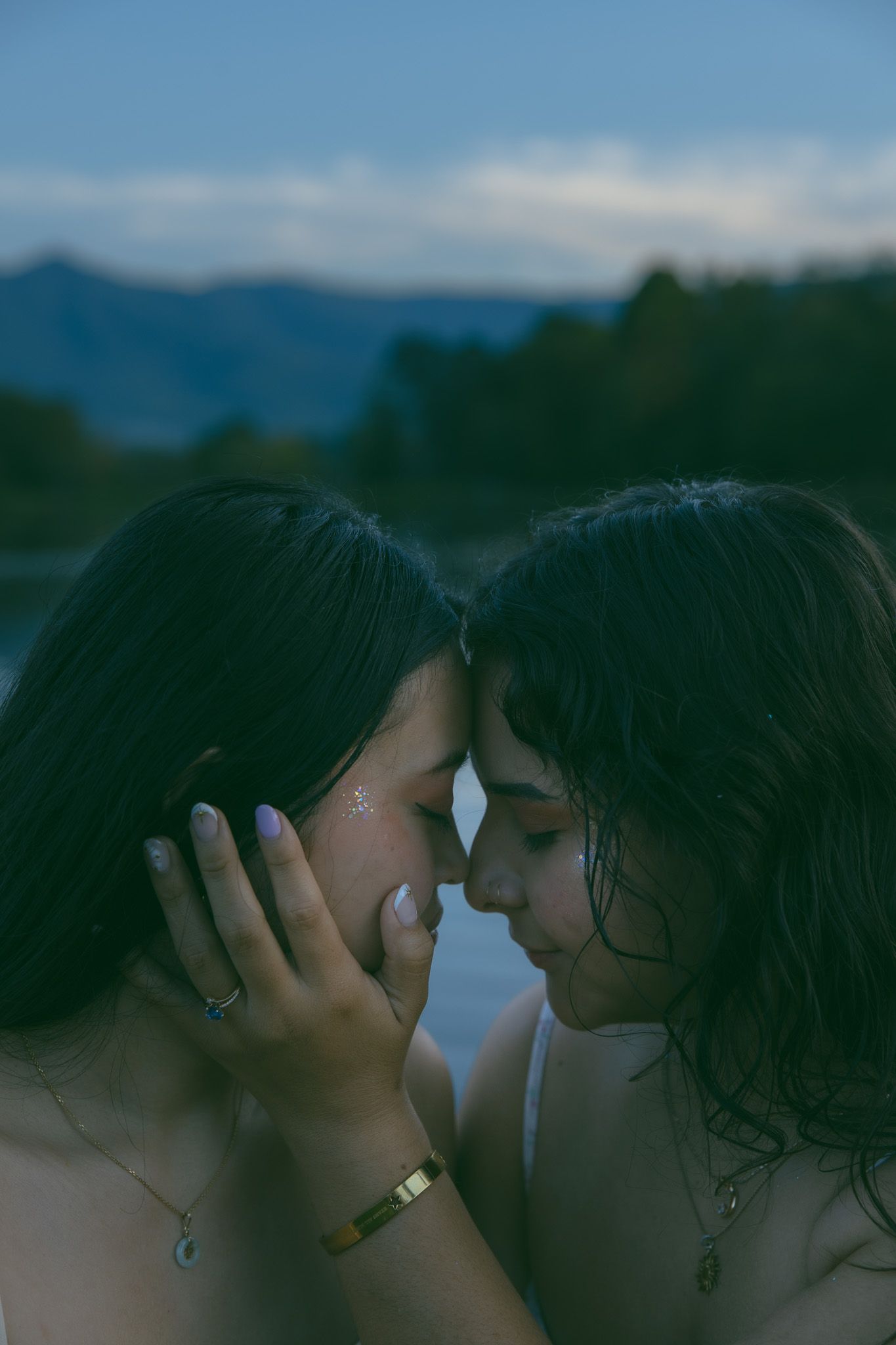 LGBTQ couple holding hands after romantic proposal at blue ridge mountain overlook near Asheville, North Carolina