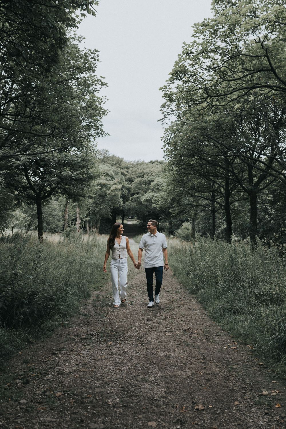 rivington pre wedding engagement photography session couple walking in forest