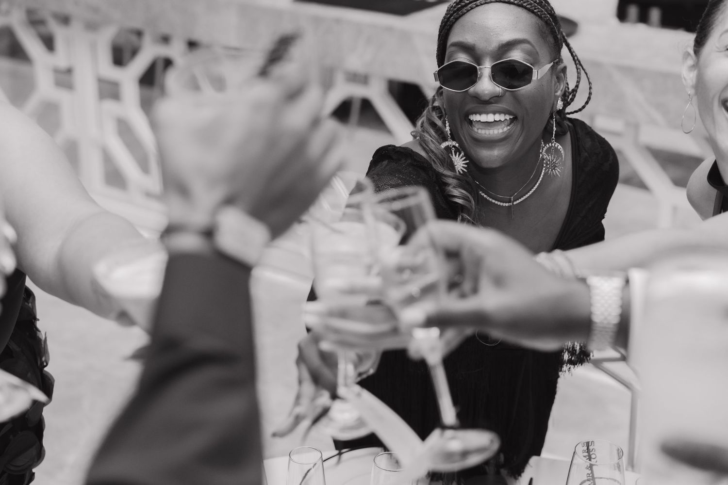 Wedding guests making a toast during the reception at Majestic Elegance Costa Mujeres, captured by a Mexico wedding photographer.