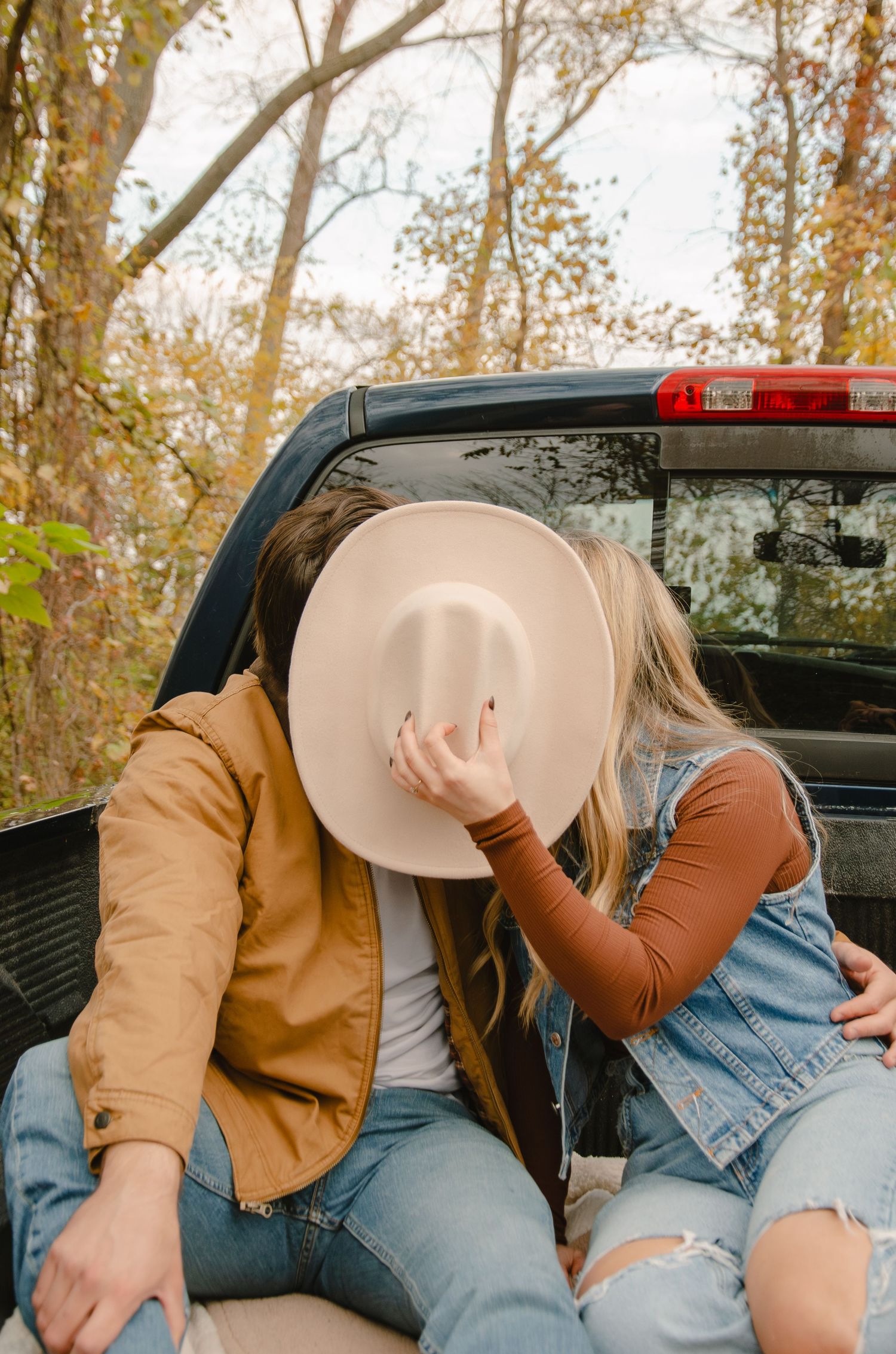 A series of casual poses showing someone in a brown jacket and ripped jeans sitting in what appears to be a truck bed.