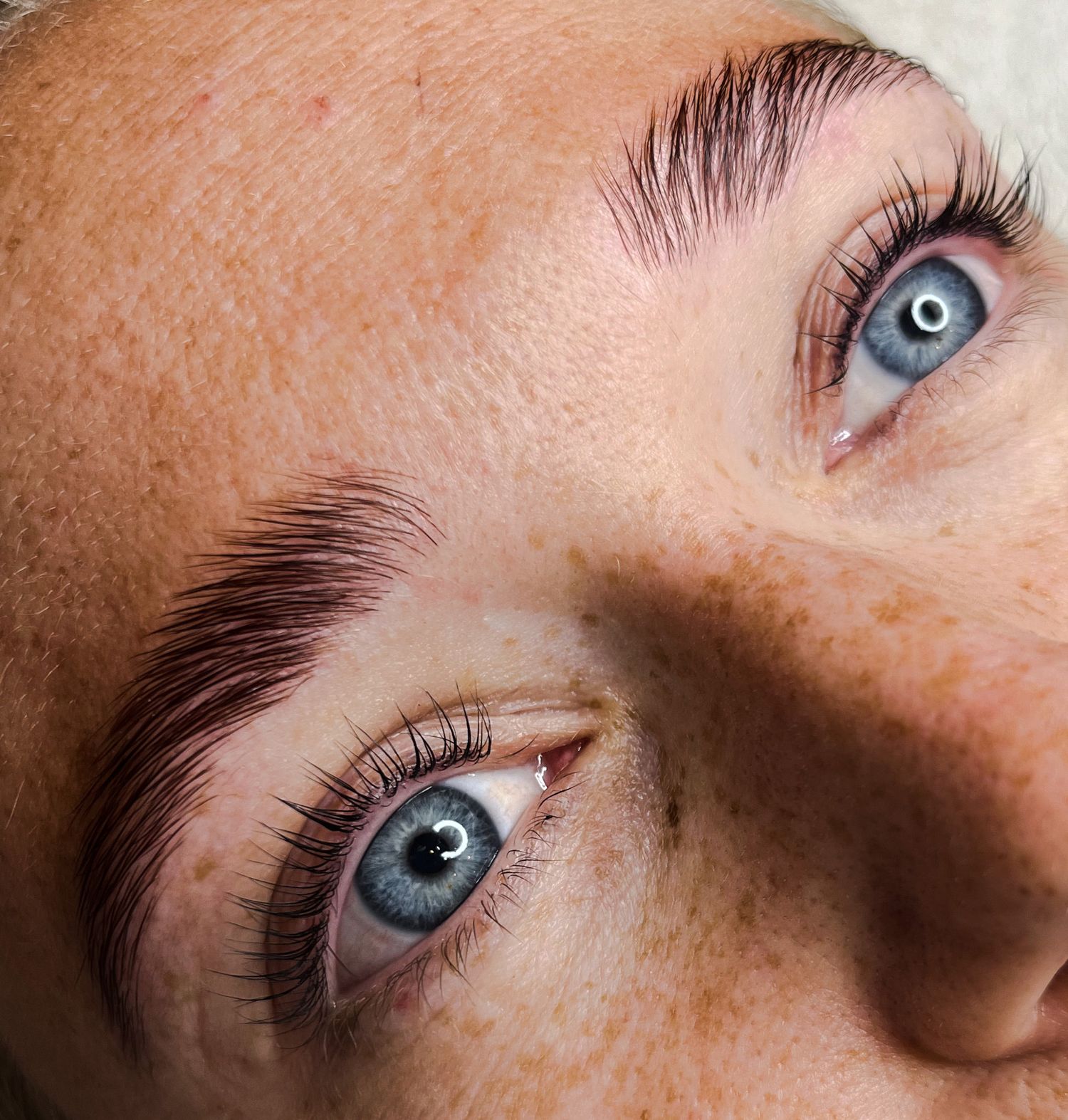 Extreme close-up sequence showing blue eyes and freckles in natural lighting.