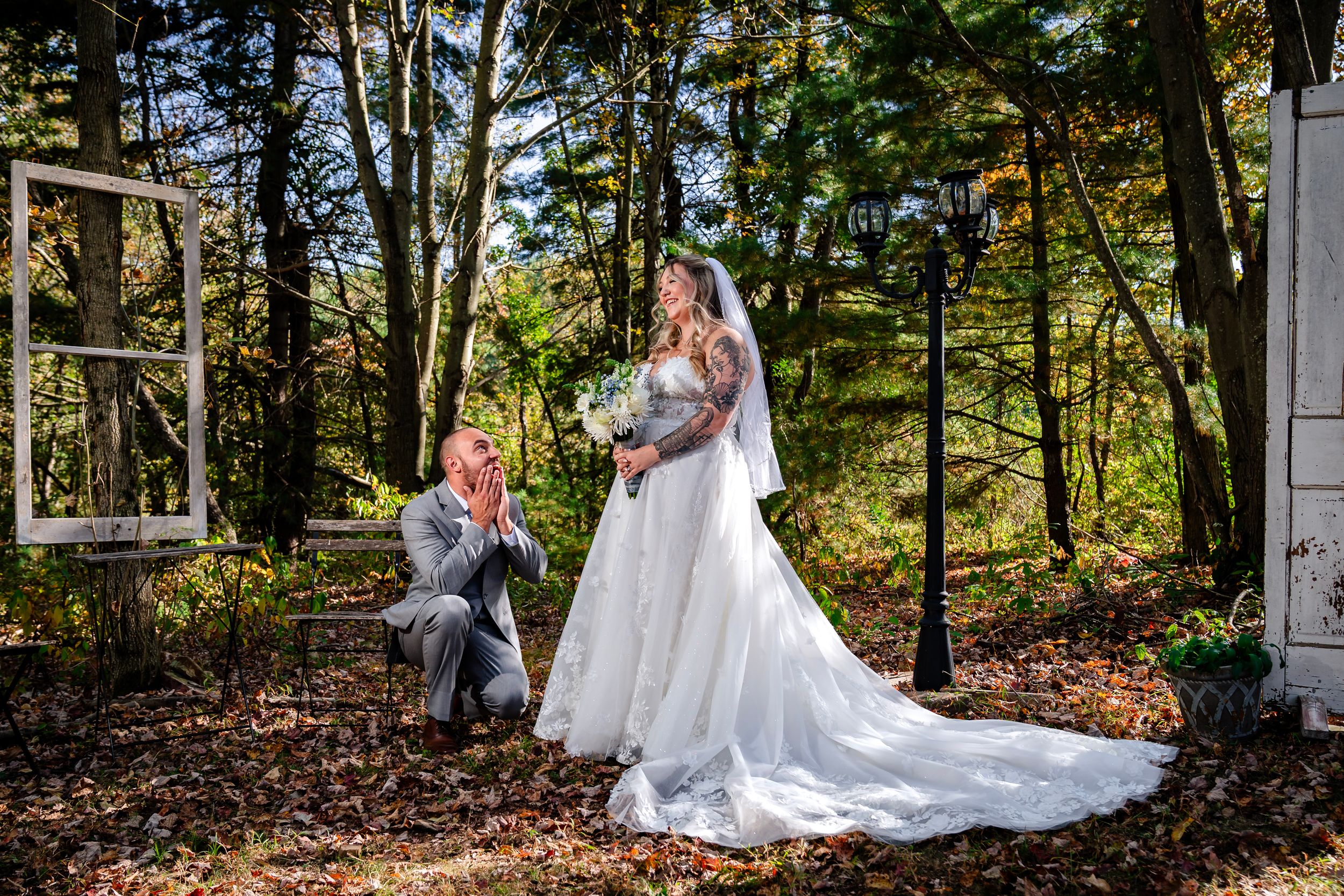 Elegant outdoor wedding scene in autumn forest with white dress and vintage window frame decor.